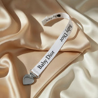 Attache tétine pour baby dior
