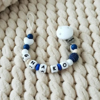 Attache tétine en silicone mam en bleu et blanc 