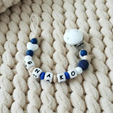 Attache tétine en silicone mam en bleu et blanc 