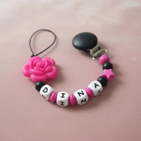 Attache tétine en silicone mam motif rose fushia 
