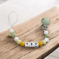 attache tetine mickey silicone poser à plat de couleur vert sauge 