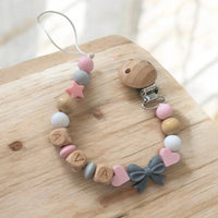 Attache tétine clip mam silicone noeud gris et perle rose pour accroche sucette 