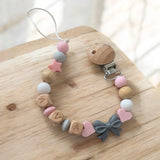 Attache tétine clip mam silicone noeud gris et perle rose pour accroche sucette 