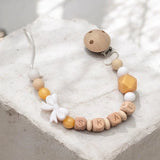 Attache tétine artisanale en silicone blanc et perles dorées avec adaptateur pour tétine Mam et clip de fixation.