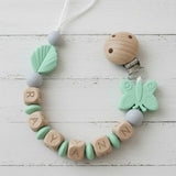 attache tetine clip de couleur menthe papillon